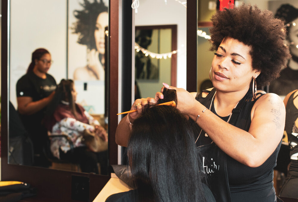 Woman getting hair combed