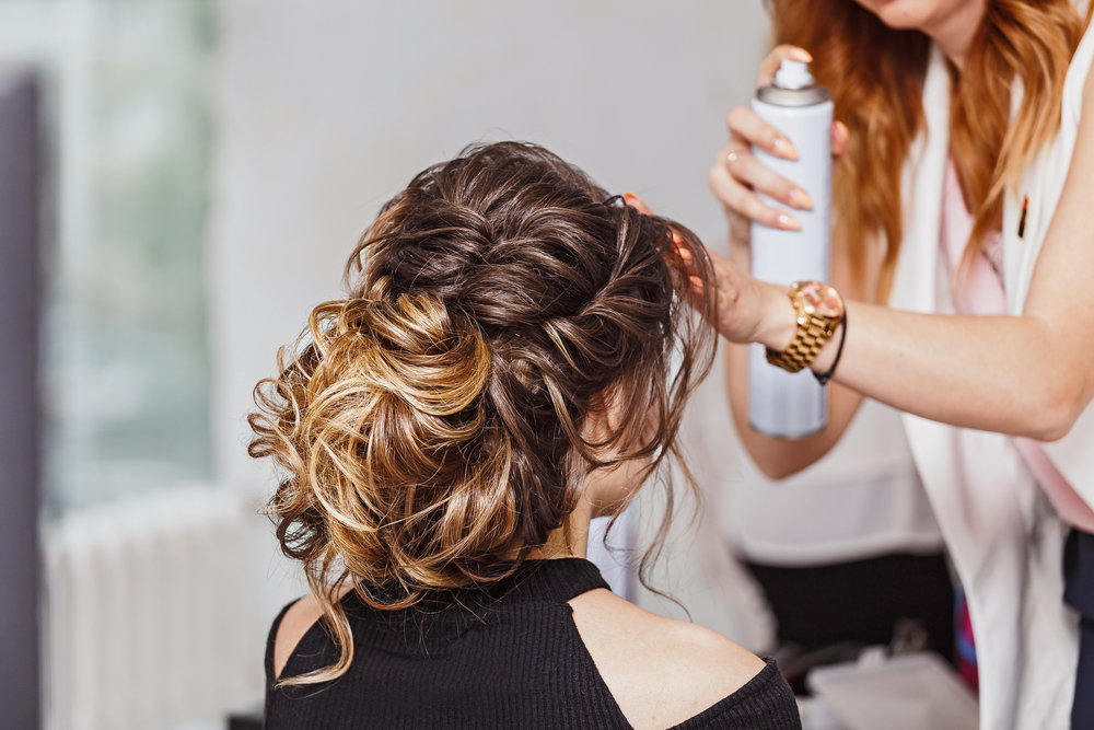 Woman getting her hair sprayed